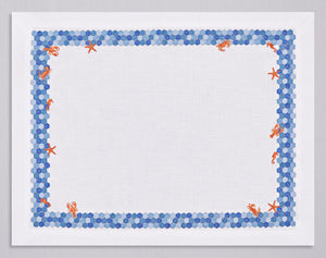 White linen placemat and napkin set embroidered with navy border and red sea animals, 100% European linen, handcrafted by Plein Soleil.