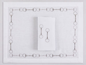White linen placemat and napkin set embroidered with gray stirrup motif border, 100% European linen, handcrafted by Plein Soleil.