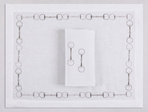 White linen placemat and napkin set embroidered with gray stirrup motif border, 100% European linen, handcrafted by Plein Soleil.