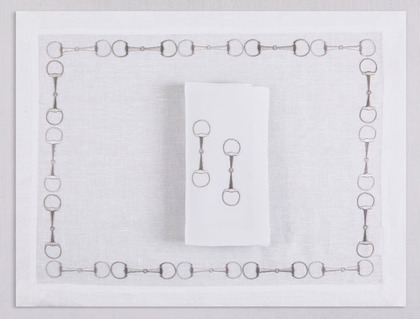 White linen placemat and napkin set embroidered with gray stirrup motif border, 100% European linen, handcrafted by Plein Soleil.