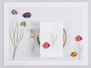 White linen placemat and napkin set embroidered with colorful tropic fish, 100% European linen, handcrafted by Plein Soleil.