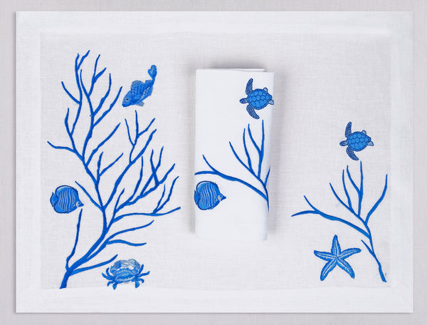 White linen placemat and napkin set embroidered with blue fish and corals, 100% European linen, handcrafted by Plein Soleil.