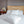 Versa Duvet Cover Set in white Egyptian cotton with geometric embroidery – flanged shams and pillowcases on bed, styled in luxury bedroom.