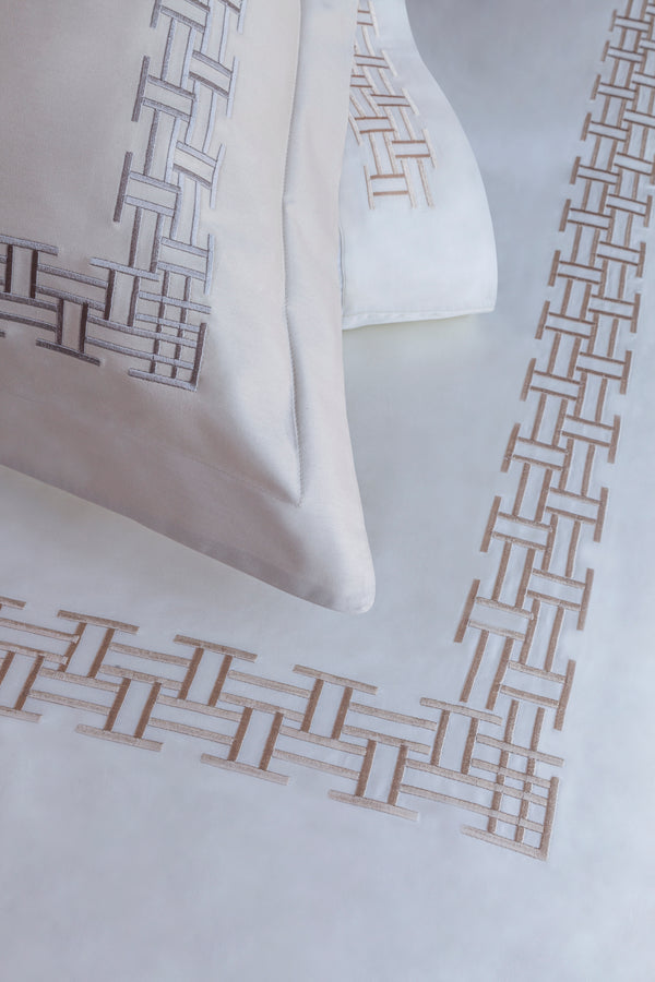 Detail of Versa Duvet Cover Set – geometric embroidered border on Egyptian cotton pillow shams and top sheet.