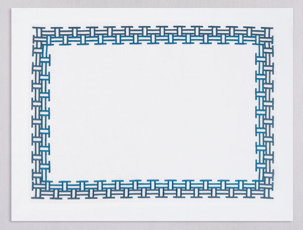 White linen placemat and napkin set embroidered with dark blue versa geometric border, 100% European linen, handcrafted by Plein Soleil.