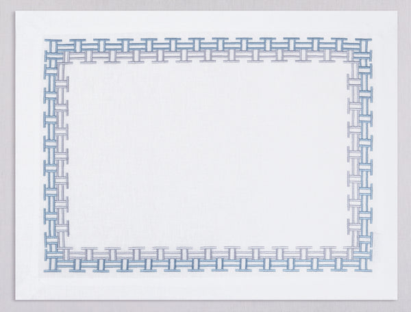 White linen placemat and napkin set embroidered with ice blue versa geometric border, 100% European linen, handcrafted by Plein Soleil.
