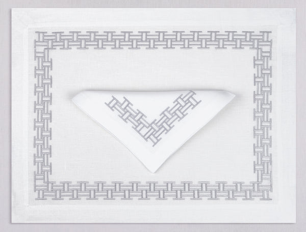 White linen placemat and napkin set embroidered with silver versa geometric border, 100% European linen, handcrafted by Plein Soleil.