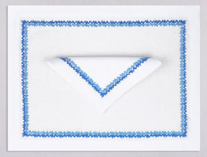 White linen placemat and napkin set embroidered with blue zig zag motif border, 100% European linen, handcrafted by Plein Soleil.