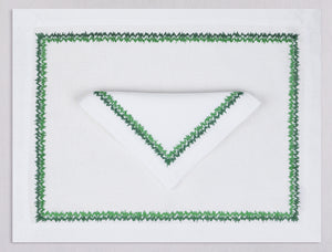 White linen placemat and napkin set embroidered with green zig zag motif border, 100% European linen, handcrafted by Plein Soleil.