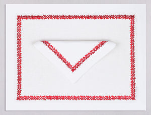 White linen placemat and napkin set embroidered with red zig zag motif border, 100% European linen, handcrafted by Plein Soleil.