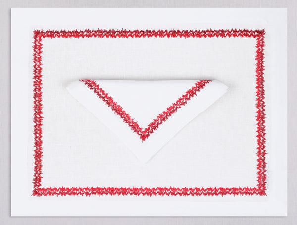 White linen placemat and napkin set embroidered with red zig zag motif border, 100% European linen, handcrafted by Plein Soleil.